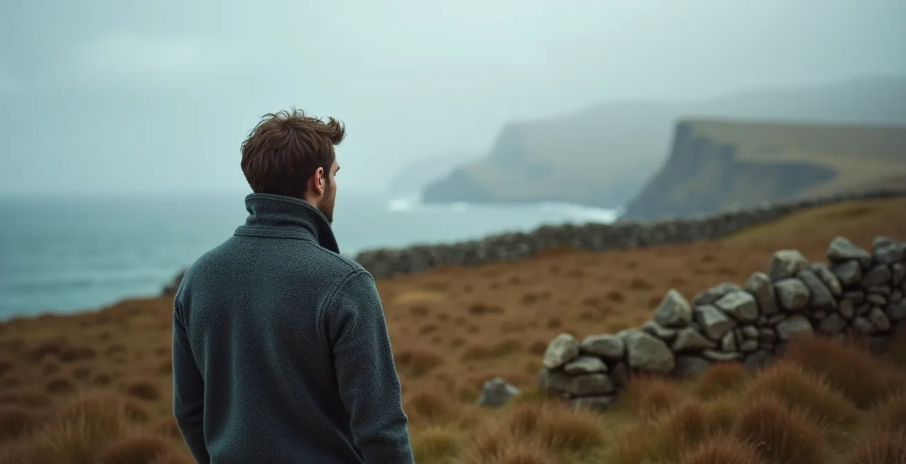 Person wearing a quality wool sweater in the misty UK countryside, demonstrating its suitability for the climate.